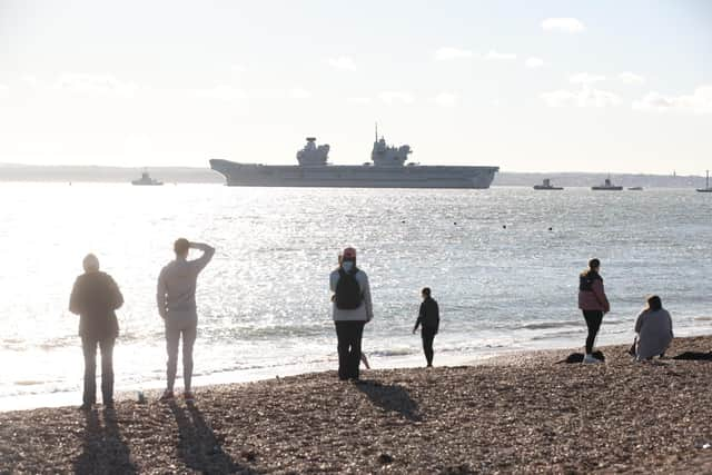 HMS Prince of Wales leaving Portsmouth for a huge Nato mission in the North Sea. Residents crowded round Old Portsmouth to watch her leave. Picture: Sam Stephenson.