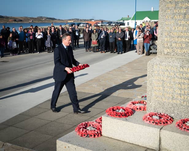 Foreign Secretary Lord David Cameron attends a wreath laying ceremony at the Falklands conflict memorial in Port Stanley on the Falkland Islands, during his high-profile visit to demonstrate they are a "valued part of the British family" amid renewed Argentinian calls for talks on their future. Picture: Stefan Rousseau/PA Wire.