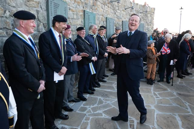 Foreign Secretary Lord David Cameron (right) attends a wreath laying ceremony at the Falklands conflict memorial in Port Stanley on the Falkland Islands, during his high-profile visit to demonstrate they are a "valued part of the British family" amid renewed Argentinian calls for talks on their future. Picture: Stefan Rousseau/PA Wire