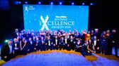The News Business Excellence Awards winners 2024 line up on the stage after an evening of celebration.
