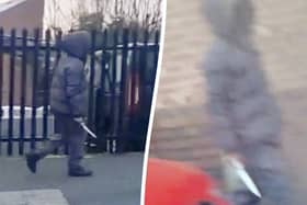 The moment a hooded knifeman casually walked down the street brandishing a huge blade near a Birmingham primary school. Picture:  Birmz Is Grime / SWNS