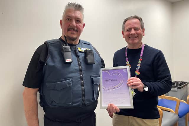 Security officer Anthony Evans receives his colleague of the month award from Solent NHS Trust chief executive Andrew Strevens