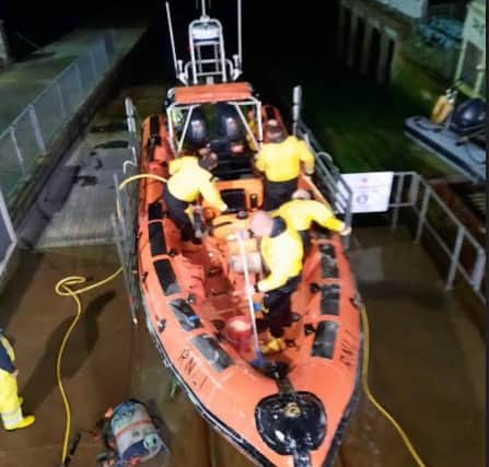 Cowes lifeboat and crew kit get a much-needed hose-down. Pic: RNLI