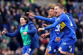 Former Pompey man Ronan Curtis celebrates after his late AFC Wimbledon winner against MK Dons. Pic: PA