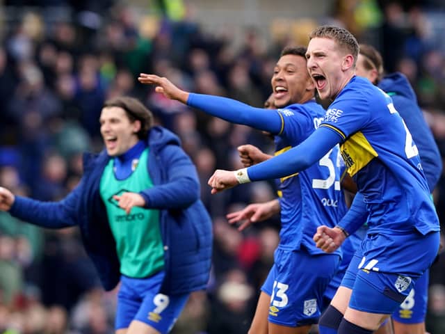 Former Pompey man Ronan Curtis celebrates after his late AFC Wimbledon winner against MK Dons. Pic: PA