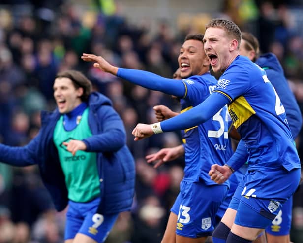 Former Pompey man Ronan Curtis celebrates after his late AFC Wimbledon winner against MK Dons. Pic: PA