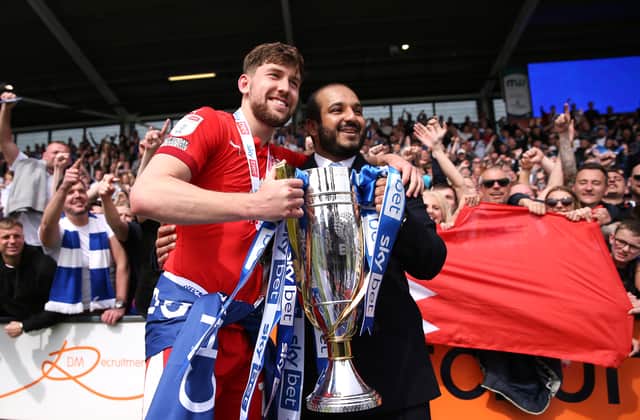 Callum Lang and Talal Hammad, the then-chairman of Wigan, celebrate with the League One trophy in April 2022. Picture: Charlotte Tattersall/Getty Images