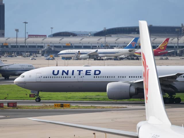 Footage captured of the moment a wheel fell off of a United Airlines Boeing 777 during takeoff, crushing cars below. Picture: Getty Images
