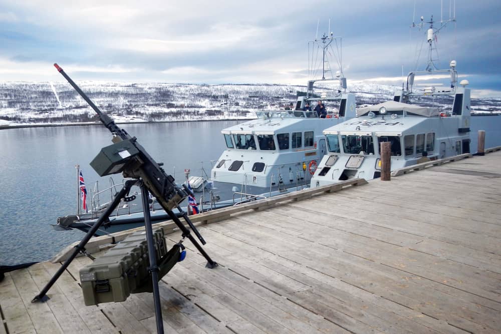 HMS Biter, Blazer, Exploit and Trumpeter have all been deployed to be a part of Nato's Exercise Steadfast Defender. Pictured is HMS Biter (nearest the jetty) and Blazer alongside in the Arctic - and a machine gun. Picture: Royal Navy
