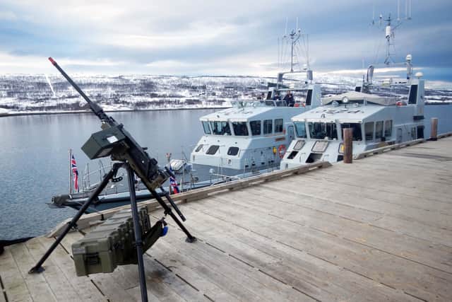 HMS Biter (nearest the jetty) and Blazer alongside in the Arctic - and a machine gun. Picture: Royal Navy