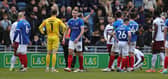 Tom McIntyre is sent off after breaking his ankle 54 minutes into his Pompey debut. Picture: Getty Images