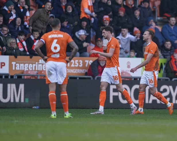 Jordan Rhodes, right, leaves the Bloomfield Road pitch following his dismissal against Pompey