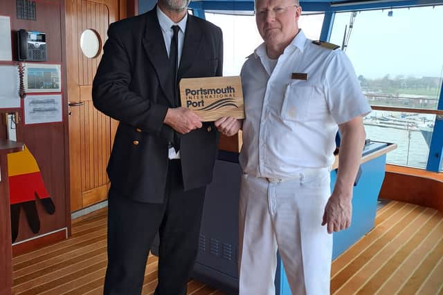 Jerry Clarke, Portsmouth International Port pilot with AIDALuna pilot Captain Sven Gärtner handing over a plaque to mark her first visit.