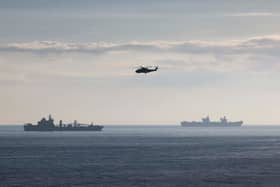 RFA TIDESURGE OPERHHMS Prince of Wales is heading the UK Carrier Strike Group on Exercise Steadfast Defender. Pictured is a Merlin Mk2 helicopter from 814 Naval Air Squadron with RFA Tidespring and HMS Prince of Wales in the background. Picture: LPhot Belinda Alker/Royal Navy
