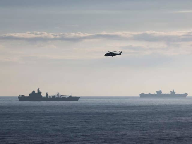 RFA TIDESURGE OPERHHMS Prince of Wales is heading the UK Carrier Strike Group on Exercise Steadfast Defender. Pictured is a Merlin Mk2 helicopter from 814 Naval Air Squadron with RFA Tidespring and HMS Prince of Wales in the background. Picture: LPhot Belinda Alker/Royal Navy