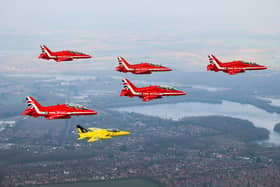 The Red Arrows fly alongside a Yellow Jack