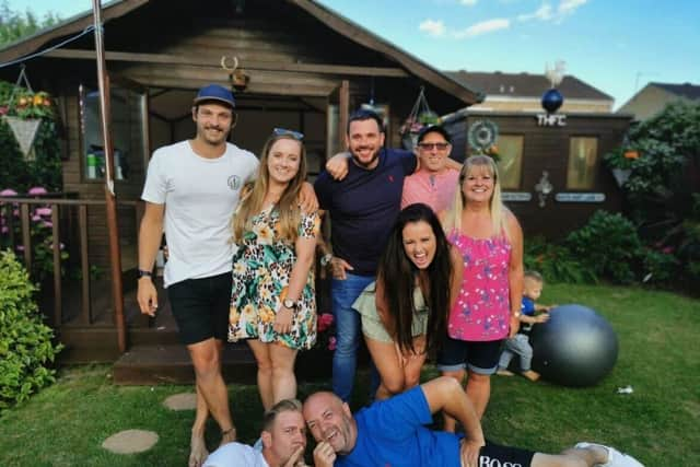 Rick, third from left, pictured with family and friends.