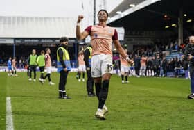 Match-winner Kusini Yengi celebrates in front of the Pompey fans at Peterborough
