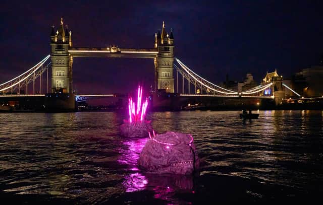 Godzilla’s bristling pink spikes, brimming with atomic power, were seen poking up from the river Thames next to Kong's giant hand, crushing an iconic London red phone box on Southbank.
The giant titan’s spine stretches an impressive 65 feet, the length of a tennis court.