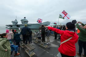 HMS Prince of Wales returns to HMNB Portsmouth, with well-wishers gathering at The Round Tower to see her. Picture: Chris  Moorhouse (260324-08)