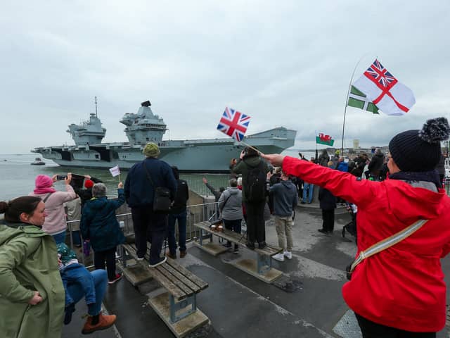 HMS Prince of Wales returns to HMNB Portsmouth, with well-wishers gathering at The Round Tower to see her. Picture: Chris  Moorhouse (260324-08)