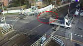 The van smashed through the level crossing barrier and dragged it along.