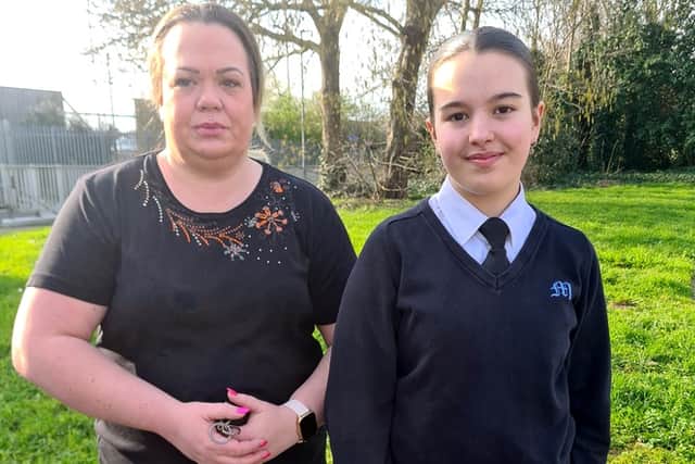 Laura, 44, with daughter Skyla Tomlin, 13, who claims she was "singled out" for wearing black trainers at school