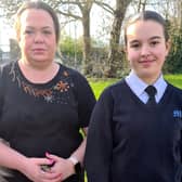 Laura, 44, with daughter Skyla Tomlin, 13, who claims she was "singled out" for wearing black trainers at school.
