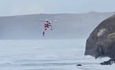 Footage capturing a dog walker being airlifted to safety after falling from a coastal path in Cornwall.  