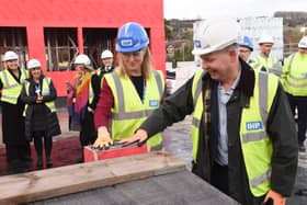 Pictured: Chief Executive of Portsmouth Hospitals University NHS Trust, Penny Emerit,  stamping her hand in one of the concrete bricks at the new A&E department at Queen Alexandra Hospital. 