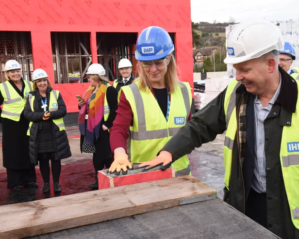 Pictured: Chief Executive of Portsmouth Hospitals University NHS Trust, Penny Emerit,  stamping her hand in one of the concrete bricks at the new A&E department at Queen Alexandra Hospital. 