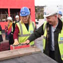 Pictured: Chief Executive of Portsmouth Hospitals University NHS Trust, Penny Emerit,  stamping her hand in one of the concrete bricks at the new A&E department at Queen Alexandra Hospital. 