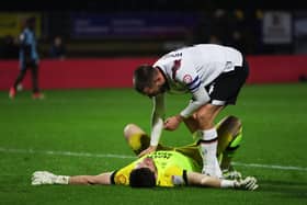 Derby keeper Joe Wildsmith is consoled by Conor Hourihane as his side drew at Wycombe - meaning a Pompey win at Bolton will seal the League One title. Pic: Getty.