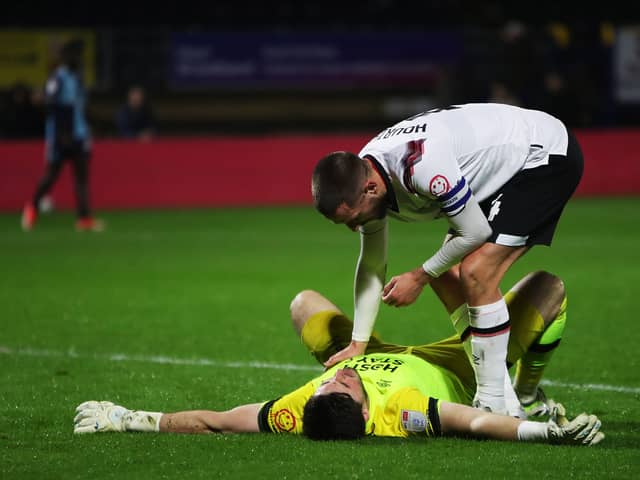 Derby keeper Joe Wildsmith is consoled by Conor Hourihane as his side drew at Wycombe - meaning a Pompey win at Bolton will seal the League One title. Pic: Getty.
