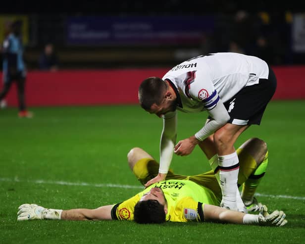 Derby keeper Joe Wildsmith is consoled by Conor Hourihane as his side drew at Wycombe - meaning a Pompey win at Bolton will seal the League One title. Pic: Getty.