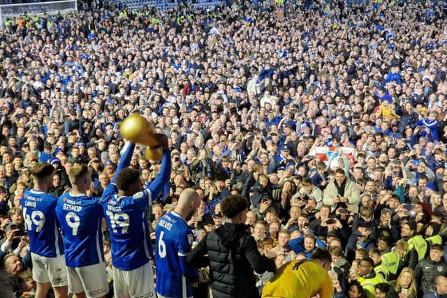 Players and fans celebrated on the Fratton Park pitch after Pompey beat Barnsley 3-2 and secured promotion to the Championship. Picture: Ian Gillespie