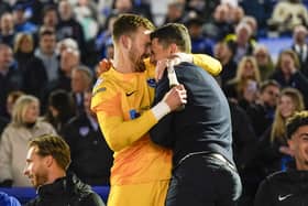 Head coach John Mousinho, right, with Blues keeper Will Norris after Pompey secured the League One title after their 3-2 win against Barnsley on Tuesday night
