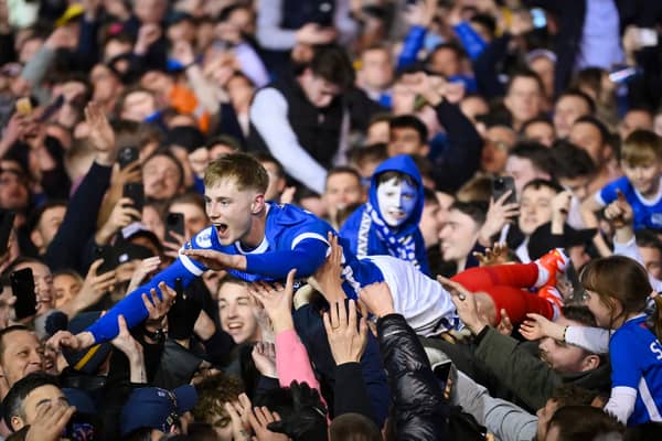 Paddy Lane crowds surf his way back to the Fratton Park tunnel as the promoton party kicks off following the Blues victory over Barnsley on Tuesday night