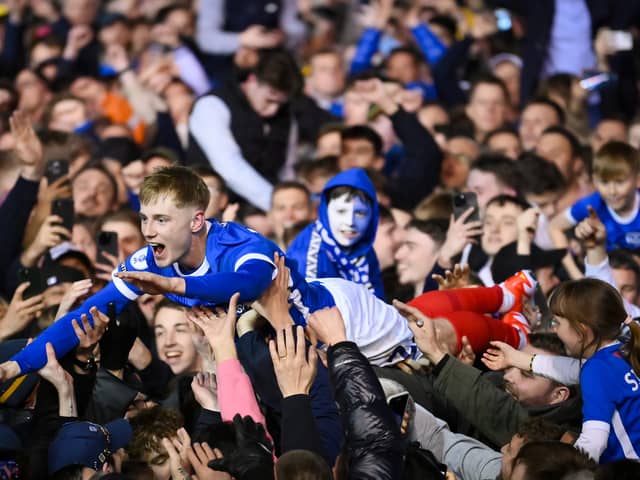 Paddy Lane crowds surf his way back to the Fratton Park tunnel as the promoton party kicks off following the Blues victory over Barnsley on Tuesday night