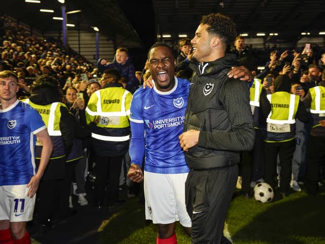 Pompey favourite Christian Saydee celebrates the League One title win against Barnsley.