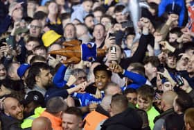 Kusini Yengi joins Pompey fans in celebration after the title win over Barnsley. Pic: Getty