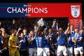 Pompey captain Marlon Pack holds aloft the League One championship trophy