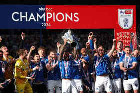 Pompey captain Marlon Pack holds aloft the League One championship trophy