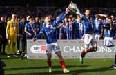 Paddy Lane and Joe Rafferty savour Pompey's League One title after Wigan defeat. Picture: Peter Nicholls/Getty Images