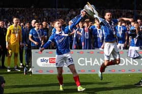 Paddy Lane and Joe Rafferty savour Pompey's League One title after Wigan defeat. Picture: Peter Nicholls/Getty Images