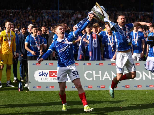 Paddy Lane and Joe Rafferty savour Pompey's League One title after Wigan defeat. Picture: Peter Nicholls/Getty Images