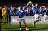 Paddy Lane and Joe Rafferty savour Pompey's League One title after Wigan defeat. Picture: Peter Nicholls/Getty Images