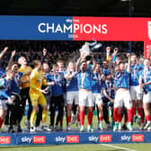 Pompey skipper Marlon Pack lifts the League One trophy. Pic: PA