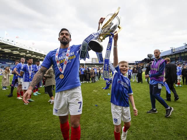 Marlon Pack and son Milan celebrate with the League One trophy on Saturday. Picture: Jason Brown/ProSportsImages