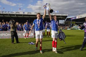 Pompey favourite Sean Raggett lifts the League One trophy with Jack Sparkes. Pic: Jason Brown.